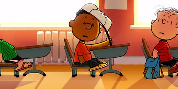 Movie still from “Snoopy Presents: Lucy's School” (2022), directed by Raymond S. Persi – A cartoon of a boy sitting at a desk; Medium shot, High angle