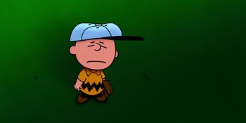 Movie still from “Snoopy Presents: Lucy's School” (2022), directed by Raymond S. Persi – Charlie brown wearing a baseball uniform and hat; Medium shot, High angle