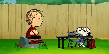 Movie still from “Snoopy Presents: Lucy's School” (2022), directed by Raymond S. Persi – A boy sitting on a chair next to a table; Extreme Wide shot, High angle