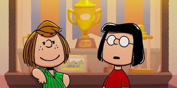 Movie still from “Snoopy Presents: One-of-a-Kind Marcie” (2023), directed by Raymond S. Persi – Two people standing next to each other in front of a trophy; Medium shot, Over the shoulder angle