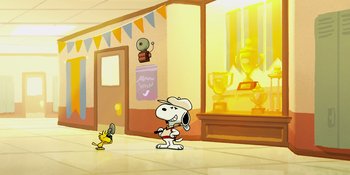 Movie still from “Snoopy Presents: One-of-a-Kind Marcie” (2023), directed by Raymond S. Persi – A cartoon of a dog and a bird in a room with trophies; Extreme Wide shot, Low angle