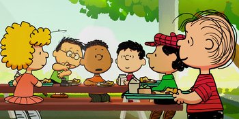 Movie still from “Snoopy Presents: One-of-a-Kind Marcie” (2023), directed by Raymond S. Persi – A group of people that are sitting at a table; Extreme Wide shot, High angle