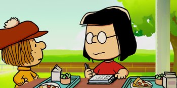 Movie still from “Snoopy Presents: One-of-a-Kind Marcie” (2023), directed by Raymond S. Persi – A woman sitting at a table with a pen in her hand; Medium shot, Over the shoulder angle
