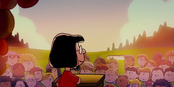 Movie still from “Snoopy Presents: One-of-a-Kind Marcie” (2023), directed by Raymond S. Persi – A crowd of people are gathered around a woman in front of a podium; Extreme Wide shot, Low angle