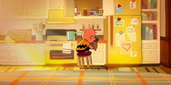 Movie still from “Snoopy Presents: To Mom (and Dad), with Love” (2022), directed by Clay Kaytis – A charlie brown sitting on a stool in a kitchen; Extreme Wide shot, High angle