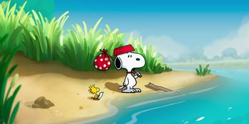 Movie still from “Snoopy Presents: To Mom (and Dad), with Love” (2022), directed by Clay Kaytis – A dog and a bird on a sandy beach near the water; Extreme Wide shot, High angle