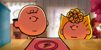 Movie still from “Snoopy Presents: To Mom (and Dad), with Love” (2022), directed by Clay Kaytis – Two people sitting in front of a plate on a table; Close Up shot, Over the shoulder angle