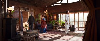 A man and a woman standing in a living room