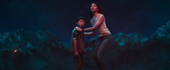 A young boy and a young girl standing next to each other