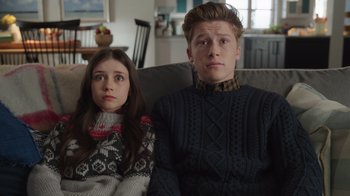 Movie still from “Snow Day” (2022), directed by Michael Lembeck – A boy and a little girl sitting on a couch; Close Up shot, Low angle