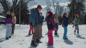 Movie still from “Snow Day” (2022), directed by Michael Lembeck – A group of children standing in the snow; Wide shot, Over the shoulder angle