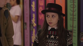 Movie still from “Snow Day” (2022), directed by Michael Lembeck – A young girl wearing a hat and a sweater; Close Up shot, Over the shoulder angle