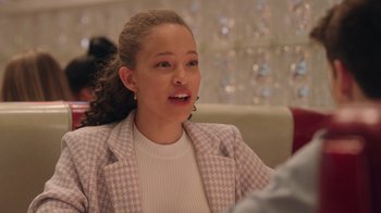 Movie still from “Snow Day” (2022), directed by Michael Lembeck – A woman in a white shirt and a purple jacket; Close Up shot, Over the shoulder angle
