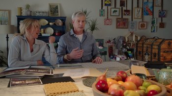 Movie still from “Snow Day” (2022), directed by Michael Lembeck – A man sitting at a table in front of a bowl of fruit; Medium shot, Over the shoulder angle
