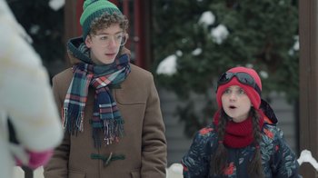 Movie still from “Snow Day” (2022), directed by Michael Lembeck – A boy and a little girl standing next to each other; Medium shot, Over the shoulder angle