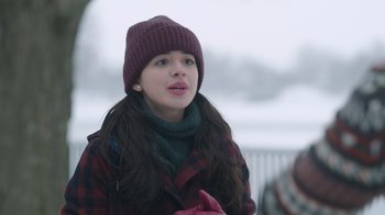 Movie still from “Snow Day” (2022), directed by Michael Lembeck – A young woman wearing a hat and a scarf; Close Up shot, Over the shoulder angle