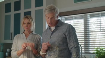 Movie still from “Snow Day” (2022), directed by Michael Lembeck – A man and a woman standing next to each other in a room; Medium shot, Low angle