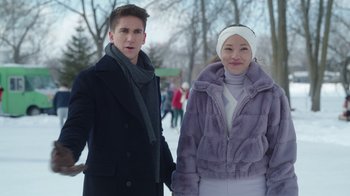 Movie still from “Snow Day” (2022), directed by Michael Lembeck – A man and a woman standing next to each other in the snow; Medium shot, Over the shoulder angle
