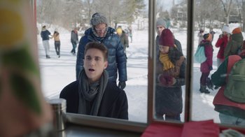 Movie still from “Snow Day” (2022), directed by Michael Lembeck – A group of people walking through the snow; Medium shot, Over the shoulder angle