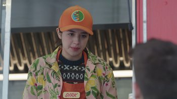 Movie still from “Snow Day” (2022), directed by Michael Lembeck – A woman wearing an apron and a hat; Close Up shot, Over the shoulder angle