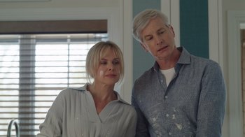 Movie still from “Snow Day” (2022), directed by Michael Lembeck – A man and a woman standing next to each other in a room; Close Up shot, Over the shoulder angle