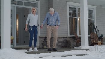 Movie still from “Snow Day” (2022), directed by Michael Lembeck – A man and a woman standing on the sidewalk; Wide shot, Low angle