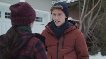 Movie still from “Snow Day” (2022), directed by Michael Lembeck – Two young men talking to each other outside in the snow; Medium shot, Over the shoulder angle
