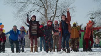 Movie still from “Snow Day” (2022), directed by Michael Lembeck – A group of people standing in the snow waving; Wide shot, Low angle