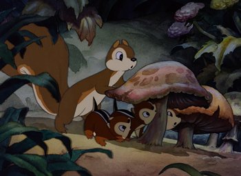 Movie still from “Snow White and the Seven Dwarfs” (1937), directed by Larry Morey – A painting of a squirrel and her babies in the woods; Wide shot, High angle