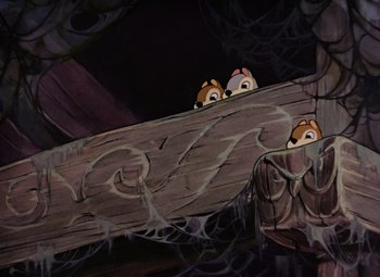 Movie still from “Snow White and the Seven Dwarfs” (1937), directed by Larry Morey – A couple of animals that are sitting on a piece of wood; Wide shot, Low angle
