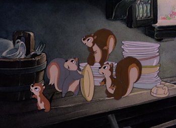 Movie still from “Snow White and the Seven Dwarfs” (1937), directed by Larry Morey – A group of cartoon squirrels sitting on top of a pile of papers; Wide shot, High angle