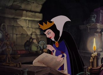 Movie still from “Snow White and the Seven Dwarfs” (1937), directed by Larry Morey – The evil queen is reading a book in the den; Medium shot, High angle