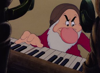Movie still from “Snow White and the Seven Dwarfs” (1937), directed by Larry Morey – An animated character is playing the piano; Close Up shot, Low angle