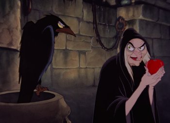 Movie still from “Snow White and the Seven Dwarfs” (1937), directed by Larry Morey – A woman in a black robe and a black bird; Medium shot, Low angle