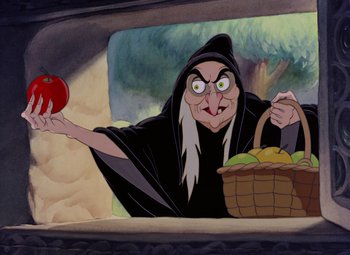 Movie still from “Snow White and the Seven Dwarfs” (1937), directed by Larry Morey – An old woman holding an apple in front of a basket of fruit; Medium shot, Over the shoulder angle