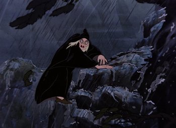 Movie still from “Snow White and the Seven Dwarfs” (1937), directed by Larry Morey – An old man in a black robe is on a cliff; Wide shot, Low angle