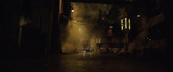 Movie still from “Solo: A Star Wars Story” (2018), directed by Ron Howard – A car is driving through a tunnel with smoke coming out of it; Extreme Wide shot, High angle