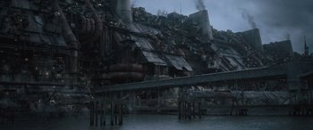 Movie still from “Solo: A Star Wars Story” (2018), directed by Ron Howard – An industrial area with a bridge over a river; Extreme Wide shot, Low angle