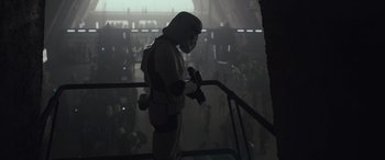 Movie still from “Solo: A Star Wars Story” (2018), directed by Ron Howard – A man in a star wars costume; Wide shot, Low angle