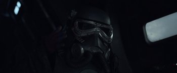 Movie still from “Solo: A Star Wars Story” (2018), directed by Ron Howard – A gas mask is shown in the dark; Close Up shot, Over the shoulder angle