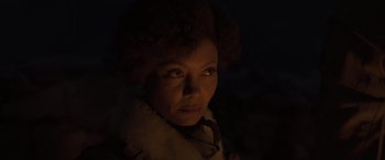 Movie still from “Solo: A Star Wars Story” (2018), directed by Ron Howard – A woman in a white coat and a black tie; Close Up shot, Low angle