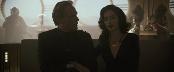 Movie still from “Solo: A Star Wars Story” (2018), directed by Ron Howard – A man and a woman sitting next to each other; Medium shot, Over the shoulder angle
