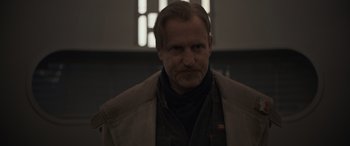 Movie still from “Solo: A Star Wars Story” (2018), directed by Ron Howard – A person wearing a jacket; Close Up shot, Low angle