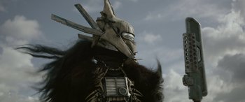 Movie still from “Solo: A Star Wars Story” (2018), directed by Ron Howard – A person wearing a mask; Close Up shot, Low angle