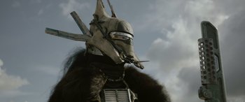 Movie still from “Solo: A Star Wars Story” (2018), directed by Ron Howard – A person wearing a mask and fur; Close Up shot, Low angle