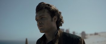 Movie still from “Solo: A Star Wars Story” (2018), directed by Ron Howard – A person wearing a jacket; Close Up shot, Low angle