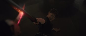 Movie still from “Solo: A Star Wars Story” (2018), directed by Ron Howard – A woman holding a red object in her hand; Medium shot, High angle