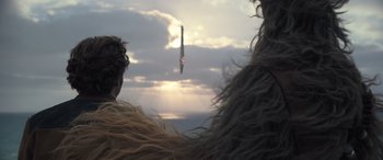 Movie still from “Solo: A Star Wars Story” (2018), directed by Ron Howard – Two people are looking at the sky at sunset; Close Up shot, Low angle