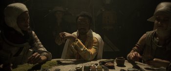 Movie still from “Solo: A Star Wars Story” (2018), directed by Ron Howard – A man sitting at a table in front of a mirror; Medium shot, Over the shoulder angle