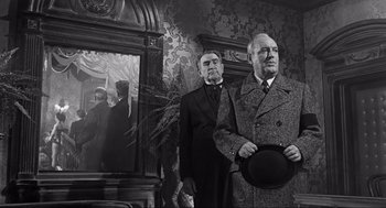 Movie still from “Some Like It Hot” (1959), directed by Billy Wilder – Two men in suits and ties standing in front of a mirror; Medium shot, Low angle